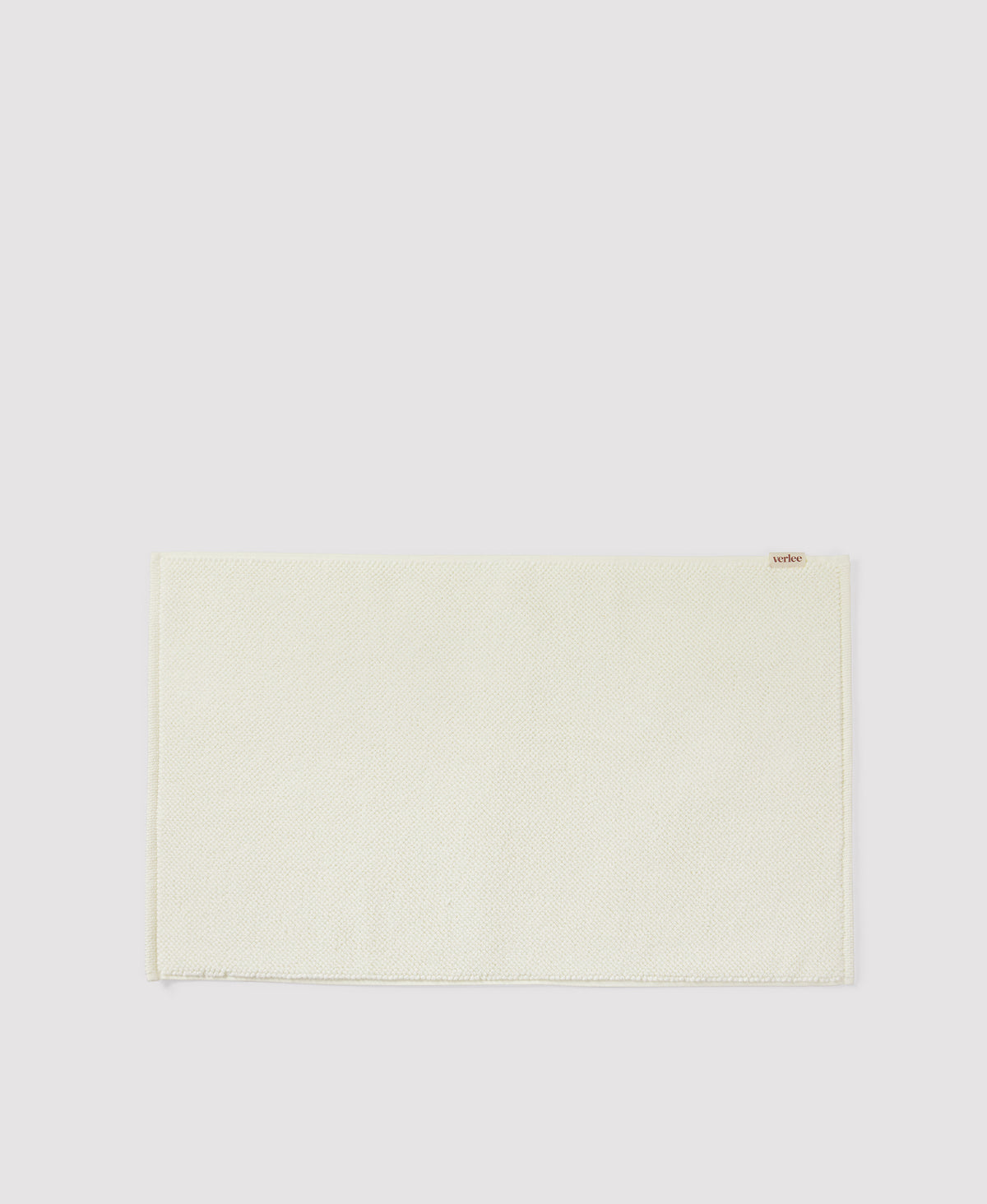 Light green woven placemat with fringed edges on white background
